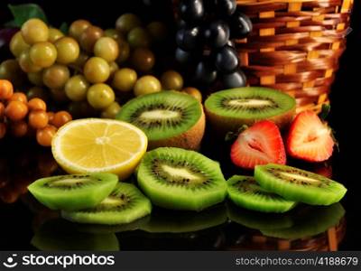 assortment of fresh fruits on black background