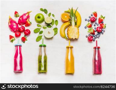 Assortment of fruit and vegetables smoothies in glass bottles with straws on white wooden background. Fresh organic Smoothie ingredients. Superfoods and health or detox diet food concept.