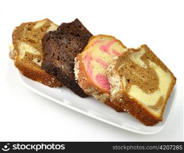 assortment of loaf cake slices , double chocolate ,raspberry swirl and cinnamon swirl.