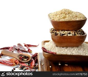 assortment of rice in wooden bowls on white background