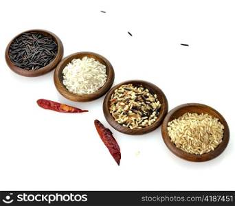 assortment of rice in wooden bowls on white background