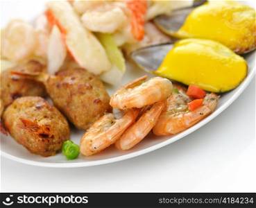 assortment of seafood on a white plate, close up