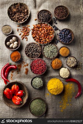 Assortment of spices in wooden bowl background