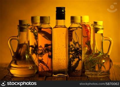 Assortment of spicy oils with herbs and spices in different bottles