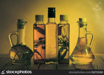 Assortment of spicy oils with herbs and spices in different bottles