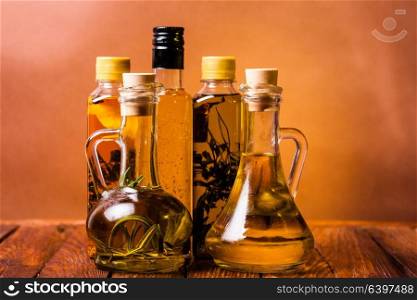 Assortment of spicy oils with herbs and spices in different bottles. Spicy oils set