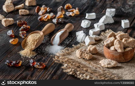 Assortment of sugar on wooden background