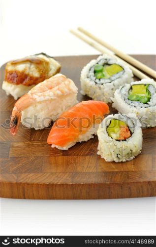 assortment of sushi on a wooden board, close up