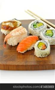 assortment of sushi on a wooden board, close up