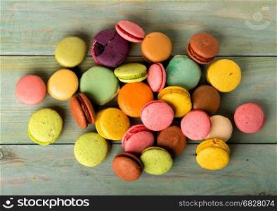 Assortment of sweet macarons on a wooden table