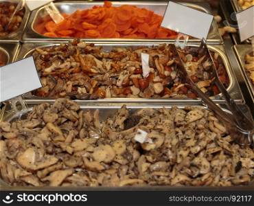 Assortment of Vegetables Preserved in Oil, Marinated Vegetables inside Metallic Bowl in Restaurant. Assortment of Vegetables Preserved in Oil: Mushrooms and Carrots