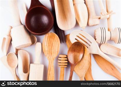 Assortment of wooden kitchen utensils on a white background