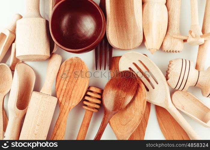 Assortment of wooden kitchen utensils on a white background. The Wooden utensils