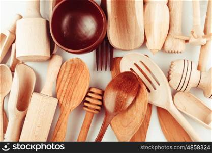 Assortment of wooden kitchen utensils on a white background. The Wooden utensils