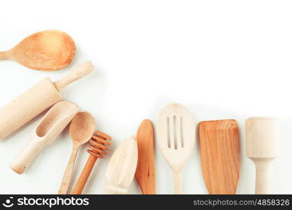 Assortment of wooden kitchen utensils on a white background. The Wooden utensils