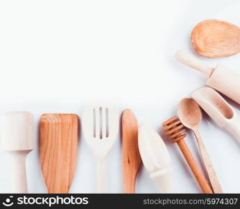 Assortment of wooden kitchen utensils on a white background. Wooden utensils