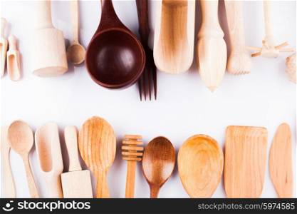 Assortment of wooden kitchen utensils on a white background. Wooden utensils