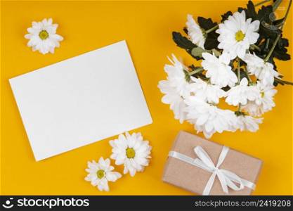 assortment white flowers with empty card wrapped gift
