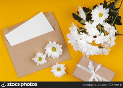 assortment white flowers with envelope wrapped gift