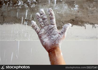 Astist plastering man hand with white dried cracked plaster texture in fingers
