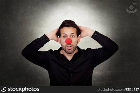 Astonished businessman with clown nose on a over gray and irregular background