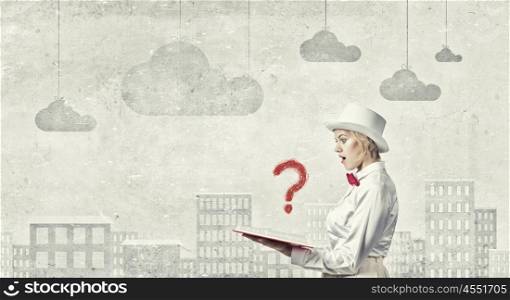 Astonished woman looking in book. Young woman in white hat with opened red book in hands