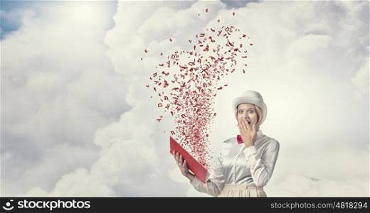 Astonished woman looking in book. Young woman in white hat with opened book in hands and characters flying out