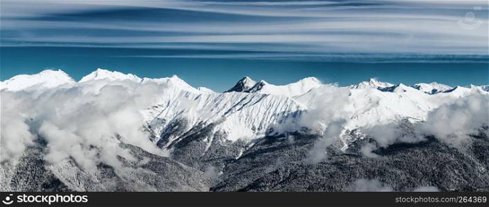 Astonishing panoramic view on Caucasus mountains from the Rosa Peak. Krasnaya Polyana (Rosa Khutor alpine ski resort), Western Caucasus, Russia.