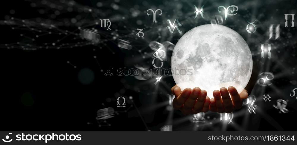Astrological zodiac signs over the moon in hand. Knowledge of the stars in the sky. The power of the universe concept.