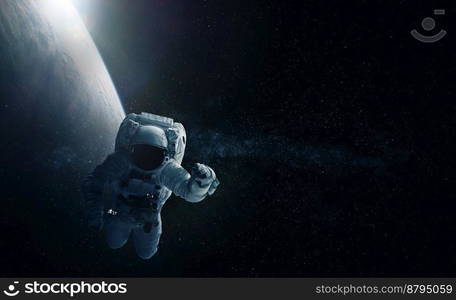 Astronaut and Earth. Elements of this image furnished by NASA.