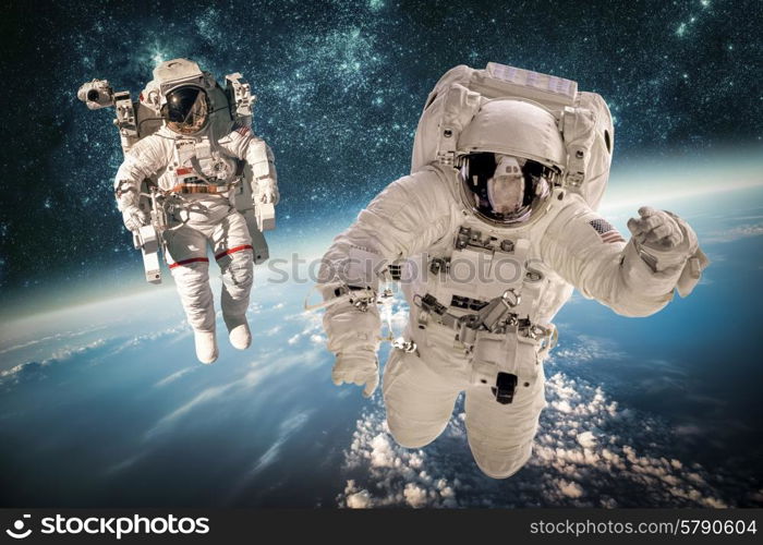 Astronaut in outer space against the backdrop of the planet earth. Elements of this image furnished by NASA.