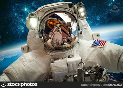 Astronaut in outer space against the backdrop of the planet earth. Elements of this image furnished by NASA.