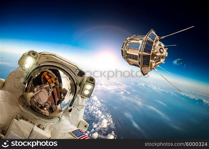 Astronaut in outer space against the backdrop of the planet earth. Elements of this image furnished by NASA.