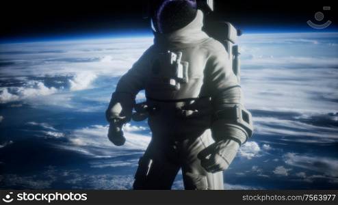 Astronaut in outer space against the backdrop of the planet earth. Elements of this image furnished by NASA.. Astronaut in outer space against the backdrop of the planet earth
