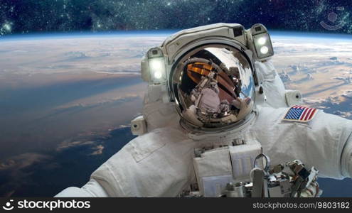 Astronaut in outer space against the backdrop of the planet earth. Elements of this image furnished by NASA.