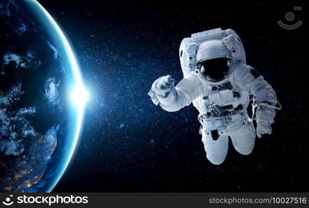 Astronaut spaceman do spacewalk while working for space station in outer space . Astronaut wear full spacesuit for space operation . Elements of this image furnished by NASA space astronaut photos.. Astronaut spaceman do spacewalk while working for space station