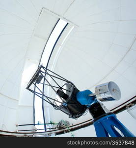 Astronomic observatory telescope inside a white dome