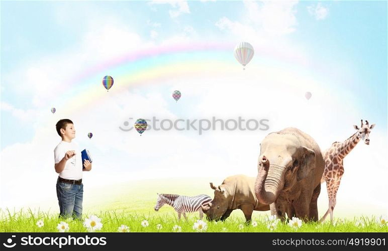At biology lesson. Boy of school age outdoor with wild animals