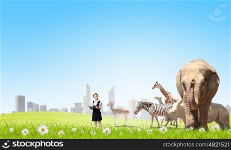 At biology lesson. Cute school girl outdoor with wild animals