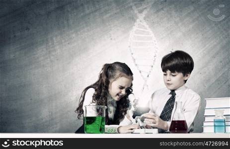 At chemistry lesson. Two cute children at chemistry lesson making experiments