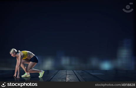 At full speed. Young woman athlete running fast on city background