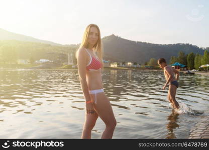 At the aquapark. Woman at aquapark and her son playing in the water