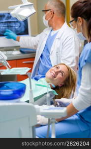 At the dentist happy woman after dental treatment lying chair