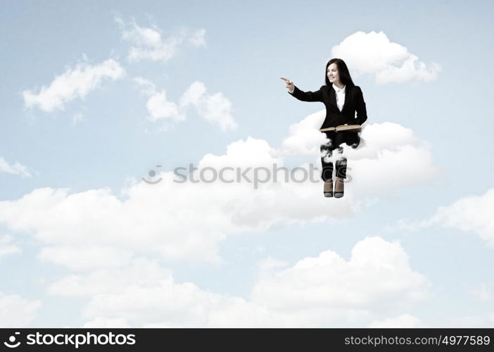 At the edge of reality and imagination. Young pretty lady with book in hands