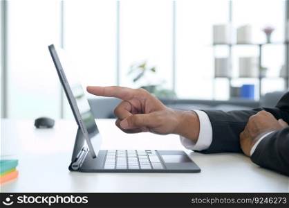 At the office, a male businessman places his hands on his laptop screen. A businessman who needs to communicate and stay in touch.