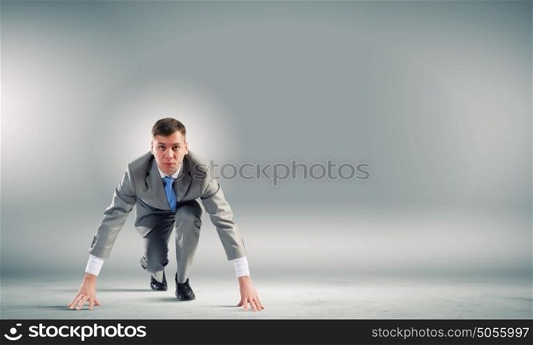 At the start of new way!. Young determined businessman standing in start position