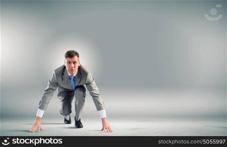 At the start of new way!. Young determined businessman standing in start position