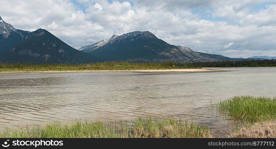 Athabasca River with mountains in the background, Jasper National Park, Alberta, Canada