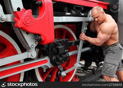 athlete checks locomotive condition