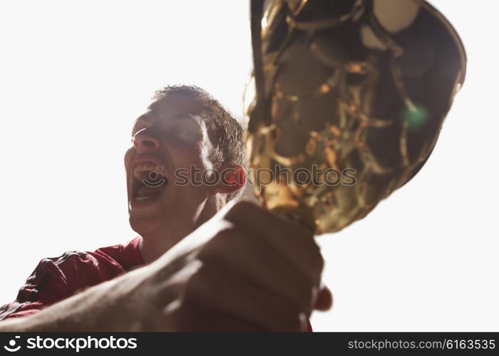 Athlete cheering with trophy cup